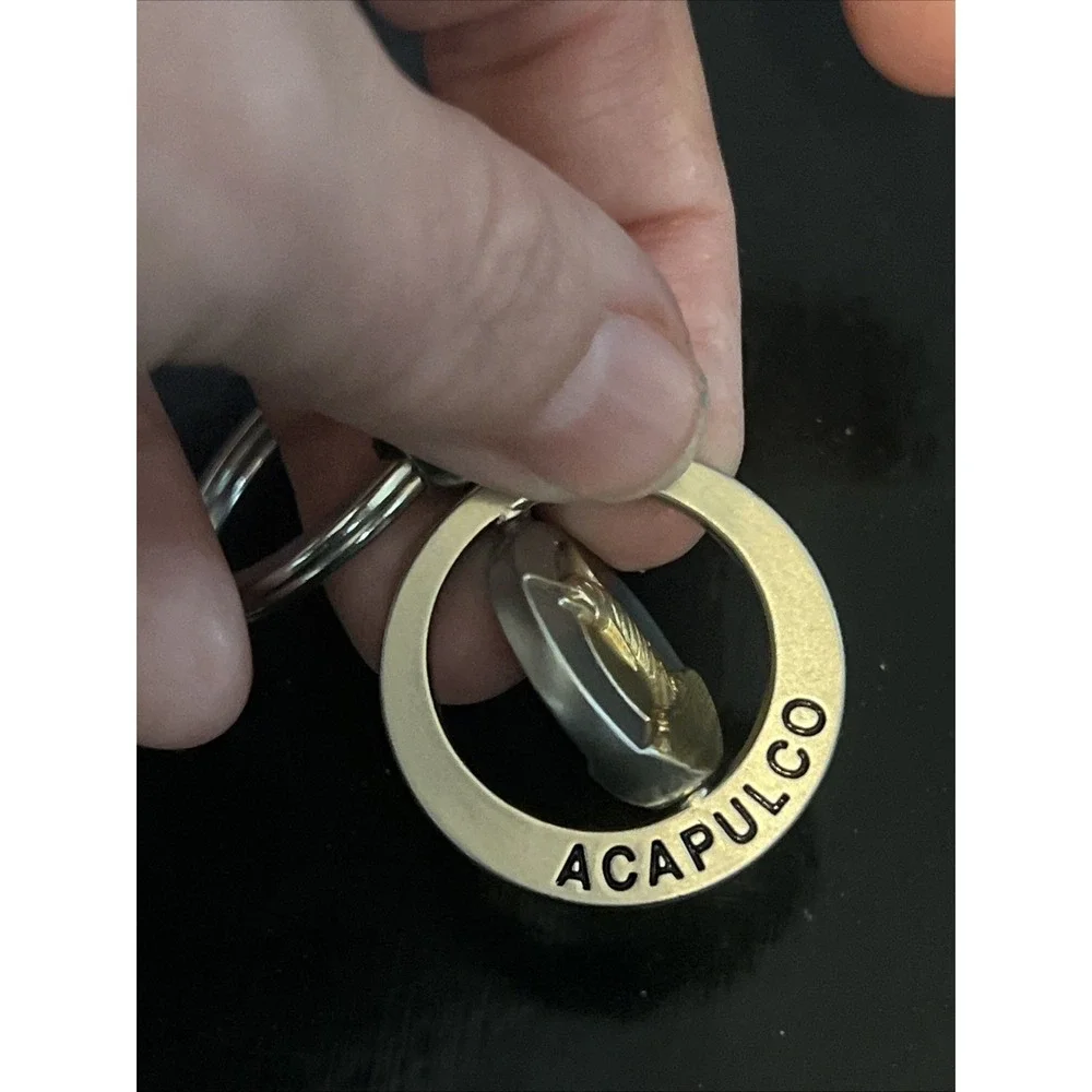 round metal Acapulco‎ souvenir keychain featuring a sailfish design